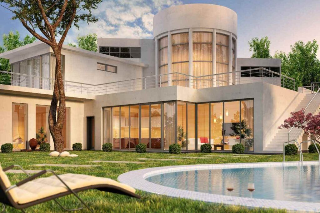 Modern luxury home with large windows and curved architectural features, overlooking a round custom plunge pool in a landscaped backyard with lounge chairs, manicured lawn, and glasses of wine placed by the poolside.