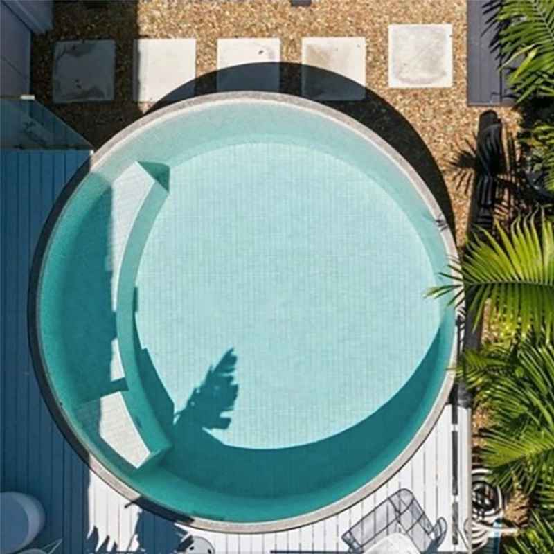 Top-down view of a round plunge pool with built-in seating and tiled interior in a compact backyard in Newcastle NSW