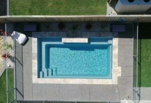 Aerial top-down view of a rectangular fibreglass swimming pool with entry steps and clean geometric design