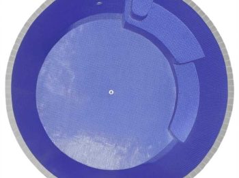 Top-down view of a round plunge pool with deep blue tiled interior, built-in seating, and curved step design in Newcastle NSW