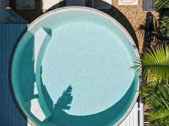 Top-down view of a round plunge pool with built-in seating and tiled interior in a compact backyard in Newcastle NSW
